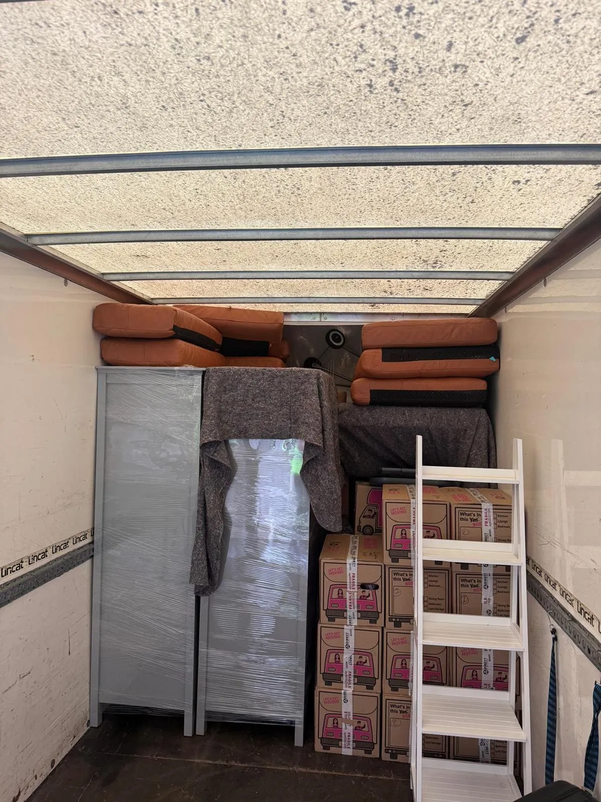 A removal van waiting on a residential street
